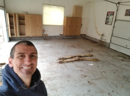 John Schott of Schott Services standing in a completely empty, swept-clean Indianapolis garage after a massive junk removal project.
