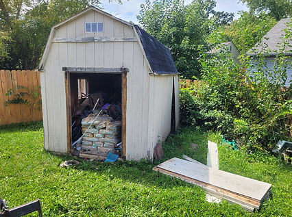 An old wooden mini barn shed in an Indianapolis backyard before demolition by Schott Services.