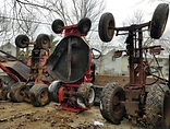 Riding lawn mowers standing on end loaded into truck.