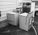 Old appliances in driveway being hauled away.