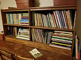 Books on a shelf to be donated.