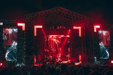 Main stage of a techno festival with a large and complex LED screen design displaying generative visual content created by Acid Thermal VJ