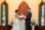 Bride and groom holding hands during a wedding ceremony