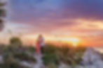 Couple embra cing on a beach at sunset