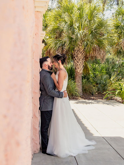 bride and groom portrait against a wall at their venue
