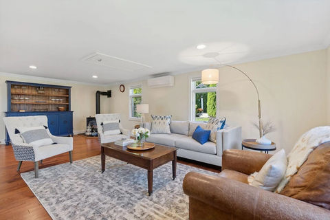 a coastal living room with a couch and two chairs