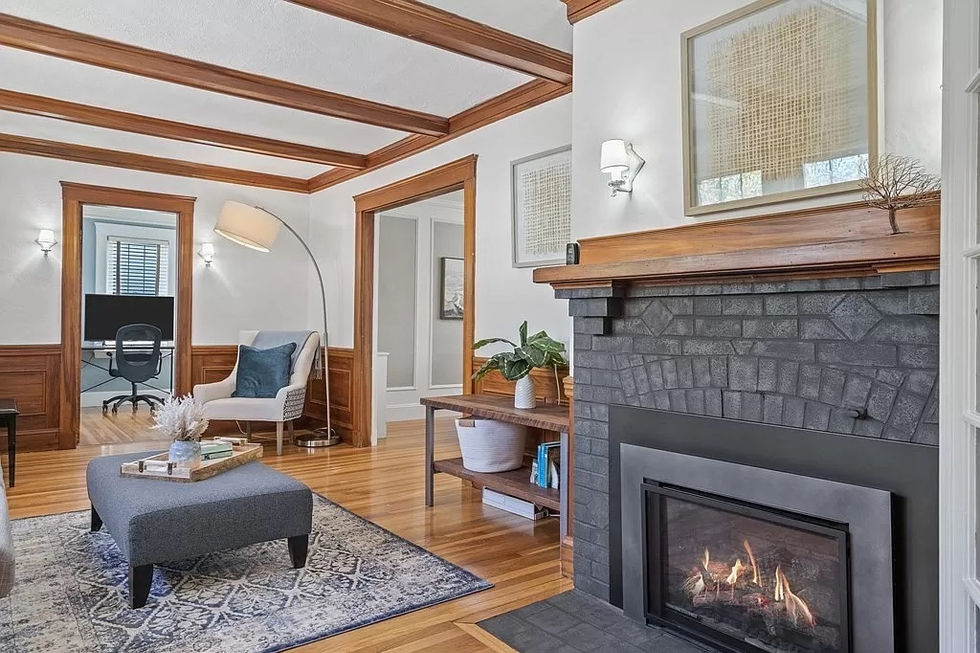 a living room with a fireplace and a chair