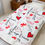 Thumbnail: image of Valentine's themed velveteen blanket on single sized bed
