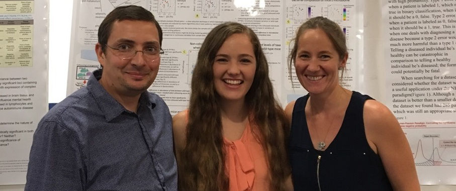 Elizabeth, Thomas and Elizabeth standing by poster presentations at research day