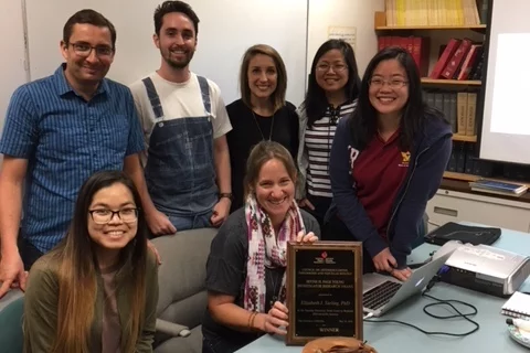 Group celebrating with cake.