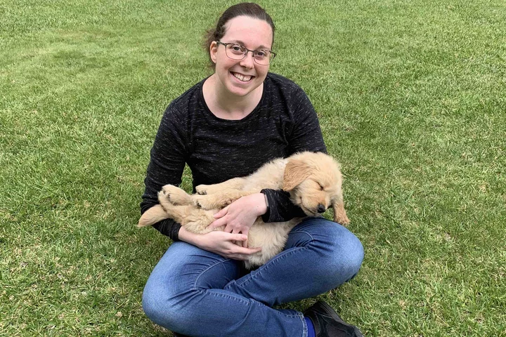 Kelsey with dog outside.