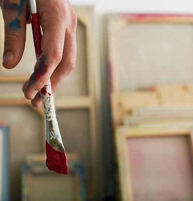 Holding a Paintbrush