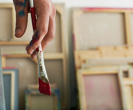 Holding a Paintbrush