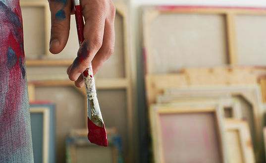 Holding a Paintbrush