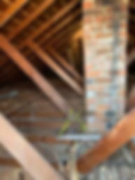 Attic space during insulation removal to prepare for new insulation