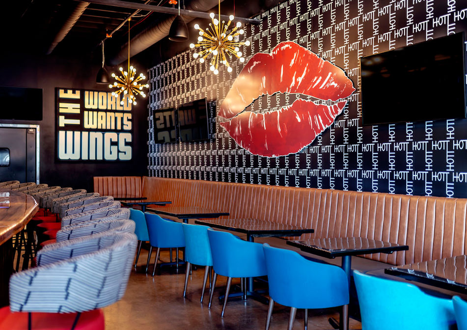 edmond restaurant edmond railyard hott wings giant lips wall decor leather banquette blue dining chairs modern whimsy interiors edmond oklahoma