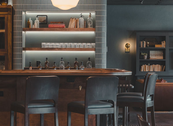 bar whiskey distillery barstools open shelving styling whiskey glasses