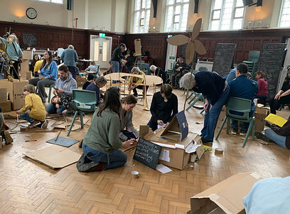 Participants in the school hall building structures from cardboard