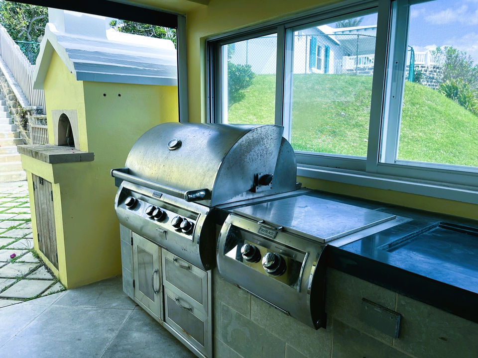 The outdoor kitchen and dining area at SeaView Luxury Vacation Rental. 