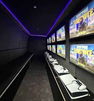 Interior of mobile gaming van with multiple screens and LED lighting gaming van hire Oxfordshire PS5 Xbox setup