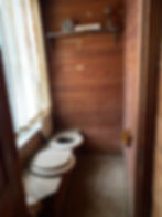 In situ double-seater privvy room. The Old Farmer's Almanac is from the 1970s but you get the idea!