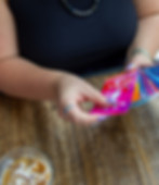 Kailee Nauman looking through her tarot deck at a coffee shop