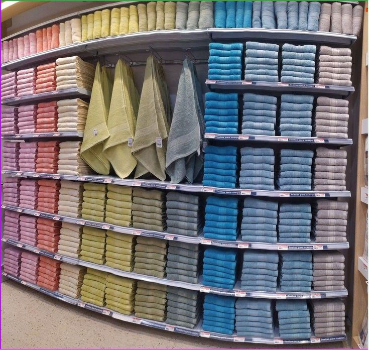 Stacks of colorful bathroom towels on retail store shelves