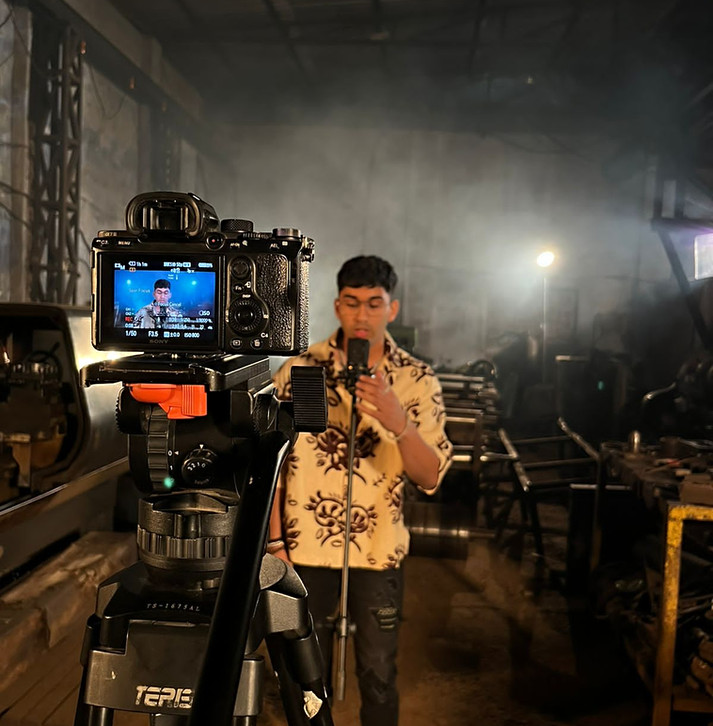 BTS picture from a music video of an independent artist, setup in an industry.