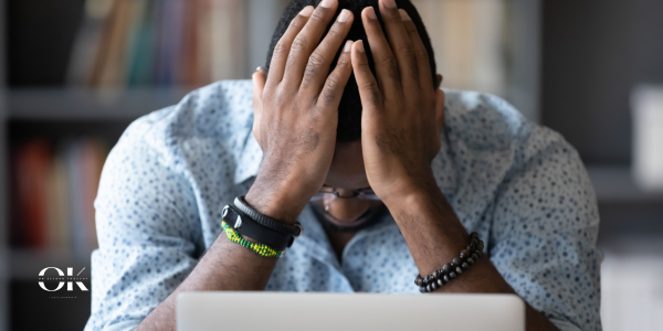 Man feeling stressed while looking at his laptop