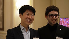Two guests smiling at a Paris Korean Club event