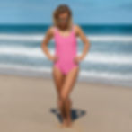 Woman in pink one-piece swimsuit on beach