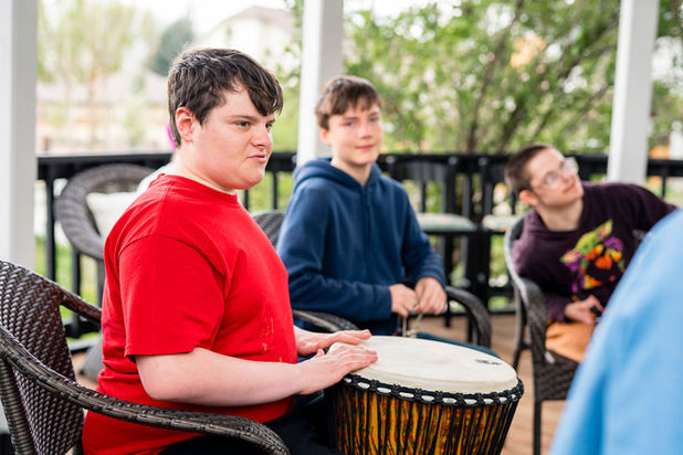 TEENAGERS PLAYING MUSIC ON DRUMS