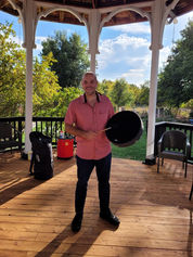 MAN HOLDING DRUM OUTSIDE