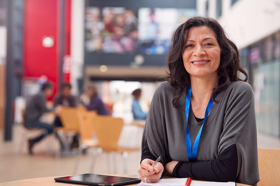 portrait-mature-female-teacher-student-with-digital-tablet-working-table-college-hall.jpg