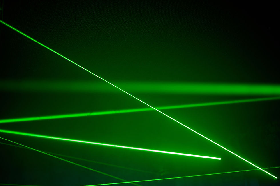 Bright green neon laser lights illuminate the darkness creating lines and triangle shapes