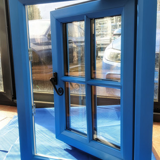 blue pvcu window with astrigal bar and monkey tail handle