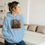 Thumbnail: Woman in light blue hoodie featuring vibrant art print