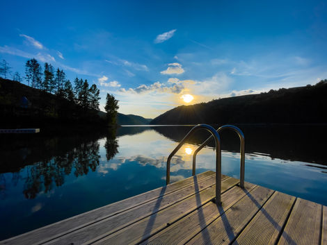 wooden-pontoon-near-a-lake-surrounded-by-forest-at-2022-09-21-04-26-13-utc.jpeg