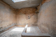 Interior de un aljibe antiguo con muros de piedra y cal.