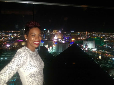 Crystal Marshall smiles confidently in a black-and-white dress, representing calm leadership and preparation under pressure.
