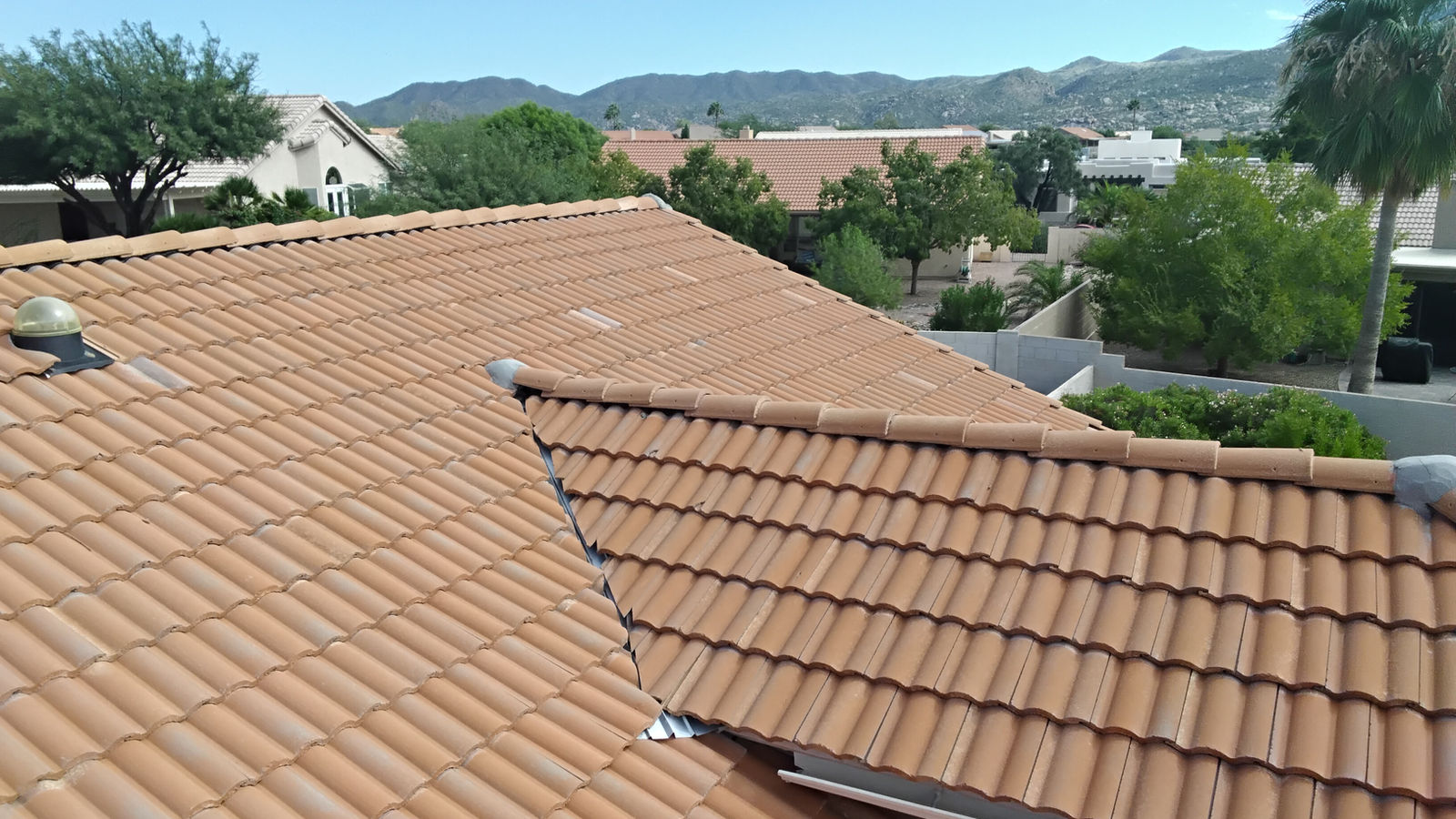 Tile roof on a Tucson home by Canyon Roofing with the mountains behind it