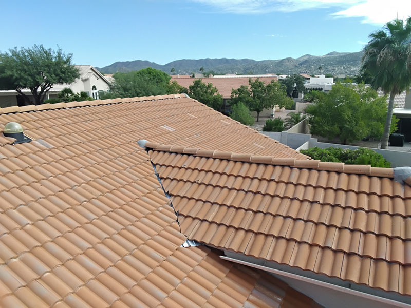 Finished concrete tile roof on a Tucson home with the mountains behind it