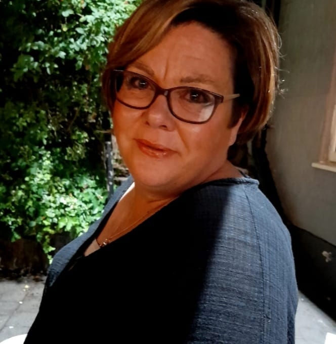 Woman with glasses and short brown hair
