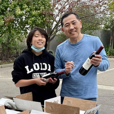 Jason Mikami and daughter Kate hand-numbering each of their Zinfandel bottles, grown in the family's west side Mokelumne River-Lodi estate.