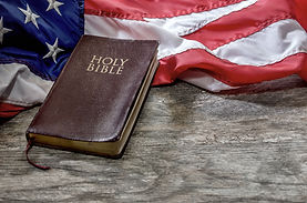 United States Flag and Bible on Distressed Wood Background.jpg