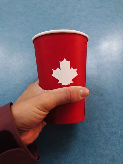 and-holding-red-cup-with-canadian-flag-2022-11-08-11-06-42-utc.jpg
