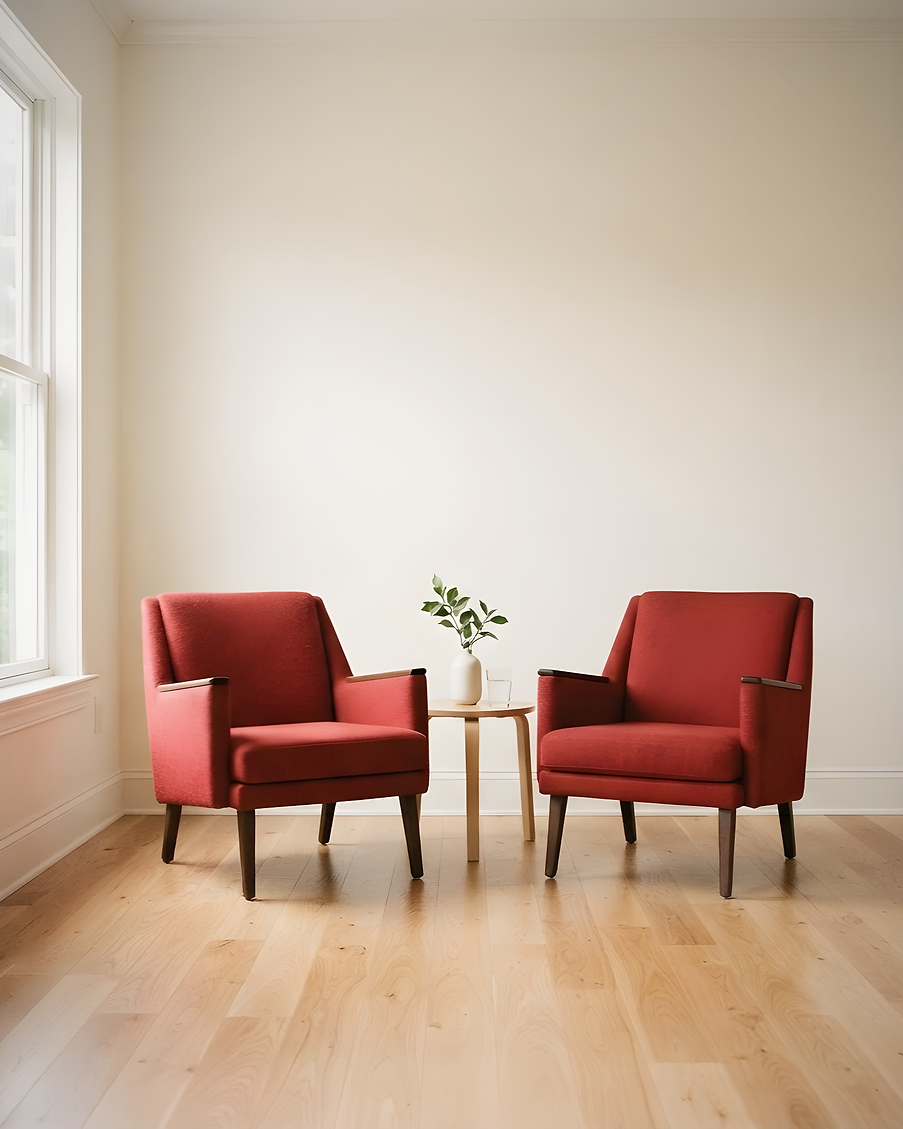 two red armchairs in an empty light room, vertical_edited.png