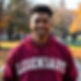 African American light skinned male in his 20's with a maroon hoodie with Legendary across
