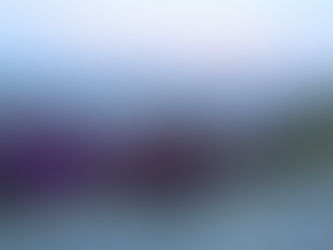 Dusk view of layered Himalayan mountain ranges fading into soft evening light.