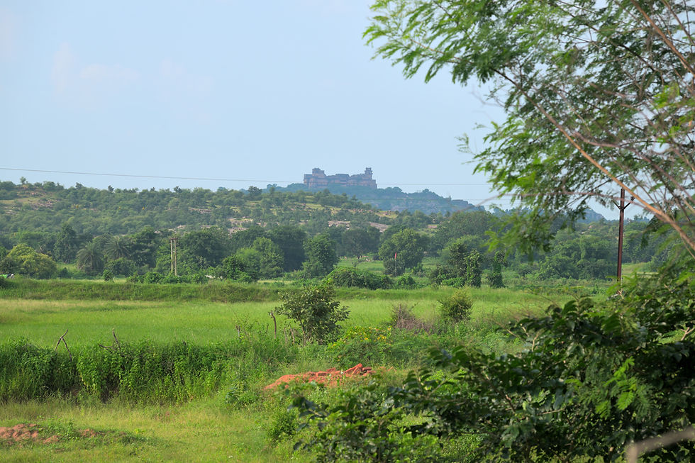 Distant view of Garh Kundar Fort above the monsoon landscape of Bundelkhand.